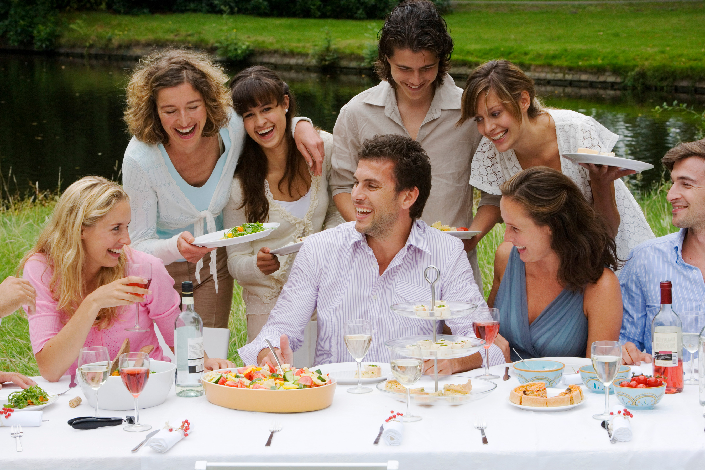 Smiling people at outdoor meal